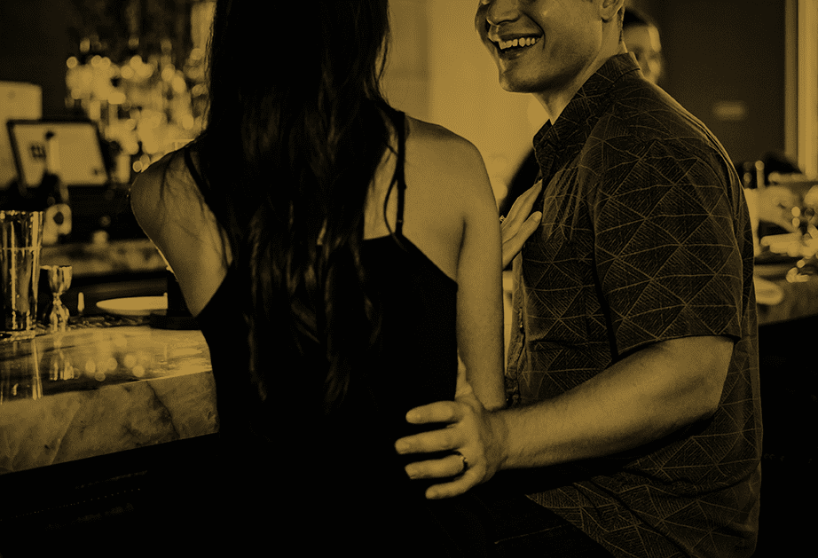 A man and woman sitting at the bar at Roth SocialHouse.